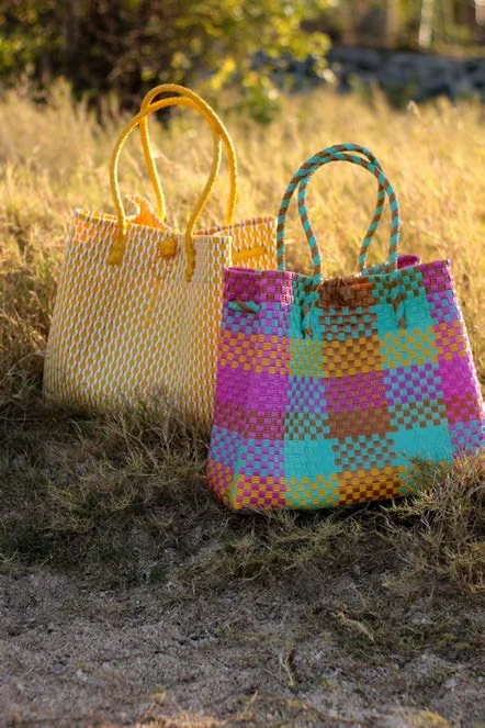 Colourful woven bags photographed outdoors